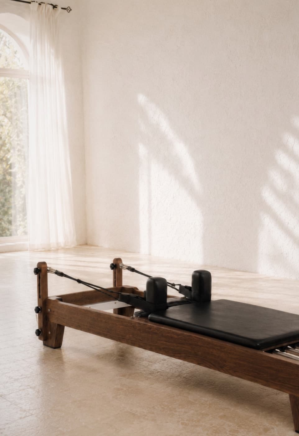A Reformer in the villa's whitewashed studio, morning light through the window